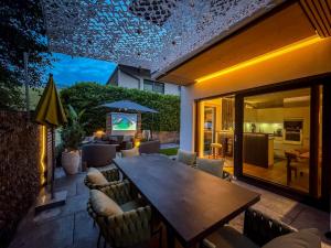 a patio with a wooden table and chairs at Mid Mountain Apartment Tirol in Wiesing