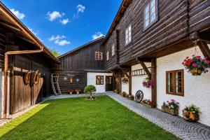 an exterior view of a barn with a yard at Penzion Sněžná Volary in Volary