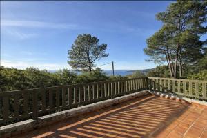 a wooden bench sitting on top of a wooden fence at Beach house within walking distance in La Teste-de-Buch