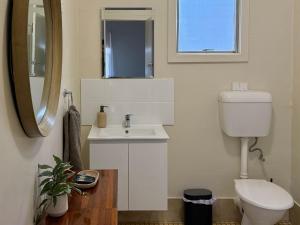 a bathroom with a sink and a toilet and a mirror at Kimba Units - Better than a motel room - self contained and pet friendly in Kimba
