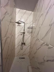 a bathroom with white marble walls and a shower at Park & Sea Townhouse in Makhinjauri +17 photos
