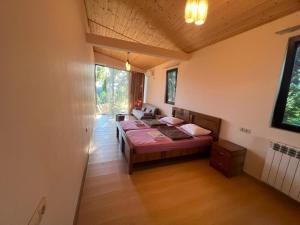 a bedroom with a bed in a room at Park & Sea Townhouse in Makhinjauri