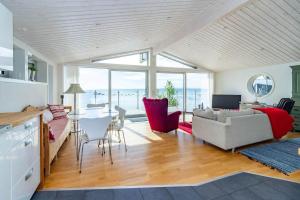 a living room with a couch and a table at VGO1064-Karlsborg-Silverdalen-1 in Karlsborg