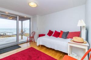 a bedroom with a bed and a view of the ocean at VGO1064-Karlsborg-Silverdalen-1 in Karlsborg