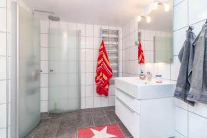 a white bathroom with a sink and a shower at VGO1064-Karlsborg-Silverdalen-1 in Karlsborg +11 photos