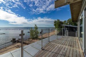 a view of the beach from the deck of a house at VGO1064-Karlsborg-Silverdalen-1 in Karlsborg