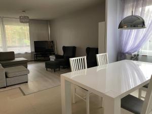 a white table and chairs in a living room at Just home in Hamina