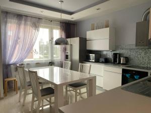 a kitchen with a table and chairs in a kitchen at Just home in Hamina