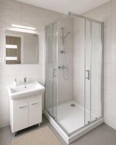 a bathroom with a shower and a sink at Pokoje gościnne Moli in Łeba +34 photos