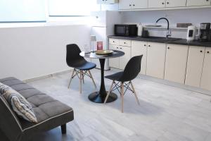 a kitchen with a table and chairs and a couch at Apartment Simply 101 in Gázion