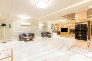 a lobby with chairs and a television in a building at Hotel Aero Star by Star Group in New Delhi