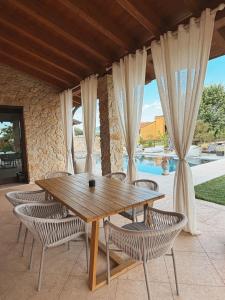 a wooden table and chairs on a patio at Residenza Monticelli in Lavagno