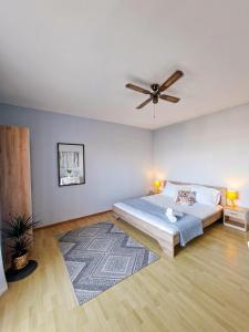a bedroom with a bed and a ceiling fan at Apartment Sofia in Kožino +66 photos