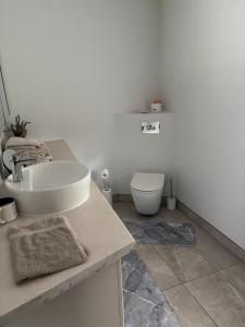 a white bathroom with a sink and a toilet at Cozy cabin near Peipsi in Raja +18 photos