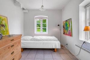 a bedroom with a bed and a window at HS025-Outrup-Strandvejen-31-B in Henne