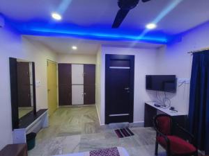a room with a blue light on the ceiling at Hotel #Blue Moon# Front Of Bhubaneswar Railway Station in Bhubaneshwar