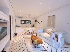 a living room with a couch and a table at Kima Surf Camp Bali Seminyak in Seminyak