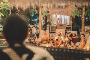 a group of people sitting on a couch at Kima Surf Camp Bali Seminyak in Seminyak