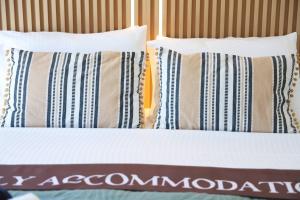 a bed with two pillows and a comforter at Apartment Simply 203 in Gázion +15 photos