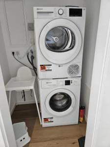 two washing machines and a washer and dryer in a room at Ferienwohnungen im Neubau in Ringen