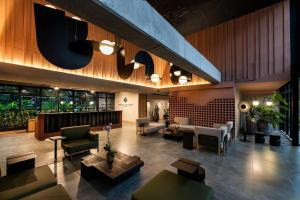 a lobby with couches and tables in a building at Faranda Collection Medellin, a Member of Radisson Individuals in Medellín