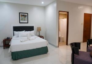 a bedroom with a bed and a living room at Ace Penzionne by Hiverooms in Pajo +24 photos