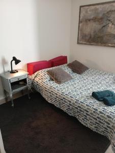 a bedroom with two beds and a table with a lamp at studio stella in Sospel
