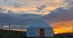 a dome tent with the sunset in the background at Sky yurt camp in Këk-Say