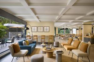 a lobby with couches and chairs and tables at Spark By Hilton Goa Calangute in Goa