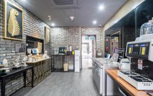 a fast food restaurant with a brick wall at 12th Street Stay in Cheongju