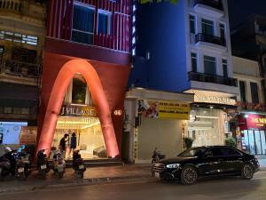 a car parked in front of a store on a city street at J Village Hotel - Triệu Việt Vương in Hanoi