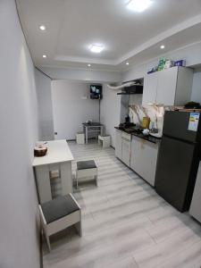 a kitchen with a counter and a table and chairs at Guest House "Markaz" in Khorog +6 photos