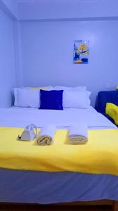 a yellow bed with a phone on top of it at Classic in Narok