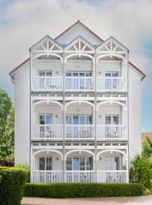 a large white building with a balcony at Neptun Hotel Kühlungsborn in Kühlungsborn