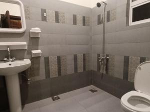 a bathroom with a toilet and a sink at ROYAL VILLA Bhurban in Murree +21 photos