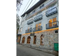 a building with balconies on the side of it at La Casa De Landour in Mussoorie