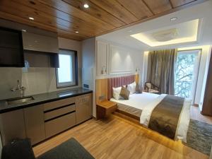 a bedroom with a bed and a sink and a television at La Casa De Landour in Mussoorie
