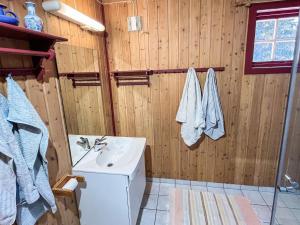 a bathroom with a sink and a toilet and wooden walls at 4 person holiday home in gol in Gol +15 photos