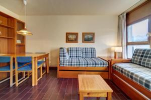 a living room with a bed and a table at Apartamentos MultiBaqueira in Baqueira-Beret +49 photos