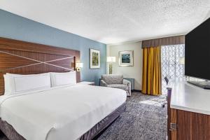 a hotel room with a large bed and a chair at DoubleTree by Hilton Milwaukee Downtown in Milwaukee +23 photos