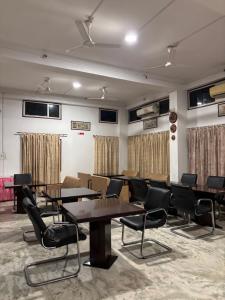 a conference room with tables and chairs in it at Hotel Nikita in Jorhat