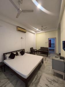 a bedroom with a bed and a tv in it at Hotel Nikita in Jorhat