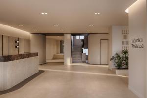 a lobby of a building with a hallway with a staircase at Atlantica Thalassa Hotel in Kos +120 photos