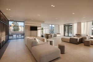a large living room with couches and a television at Atlantica Thalassa Hotel in Kos