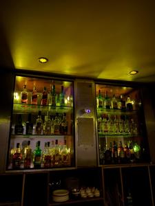 a bar filled with lots of bottles of alcohol at Hotel Nikita in Jorhat