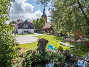 a house with a church in the background at Ferienwohnung Seeblick in Bad Bodenteich