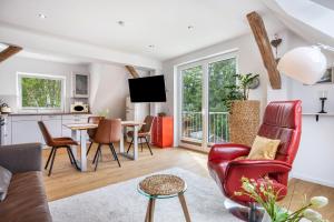 a living room with red chairs and a table at Ferienwohnung Seeblick in Bad Bodenteich