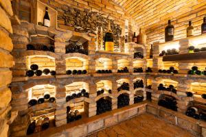 a room filled with lots of bottles of wine at Gasthof Kogelalm in Wagrain +18 photos