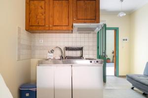 a kitchen with a sink and a stove at Lenia Studios in Kalamitsi +64 photos