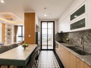 a kitchen with a table and a dining room at V Hạ Long in Ha Long